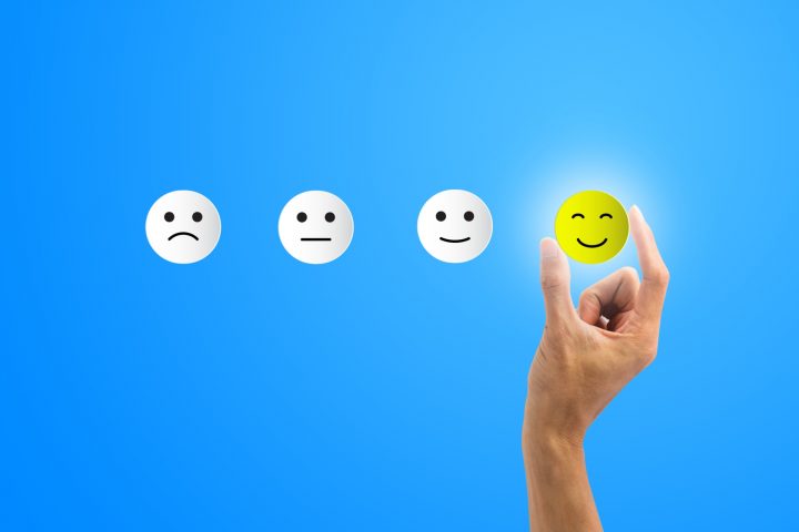 conceptual-the-customer-responded-to-the-survey-the-client-using-hand-choose-happy-face-smile-icon-on-blue-background-depicts-that-customer-is-very-satisfied-service-experience-satisfaction-concept